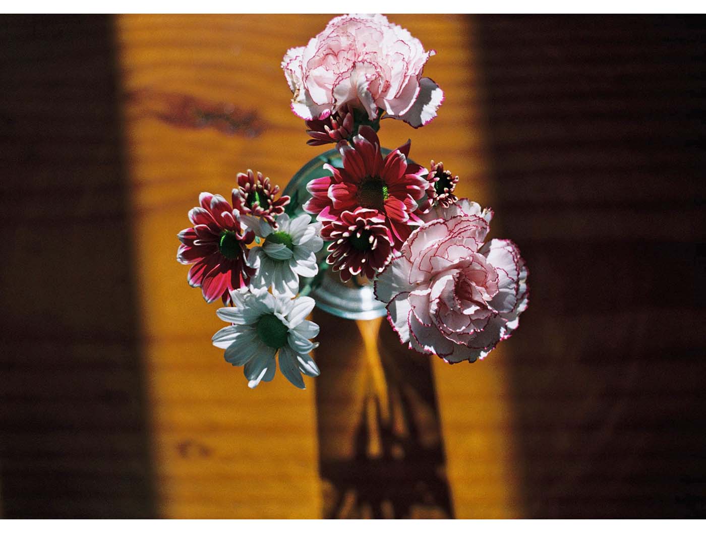 Little flower bouquet standing on on wood in the light