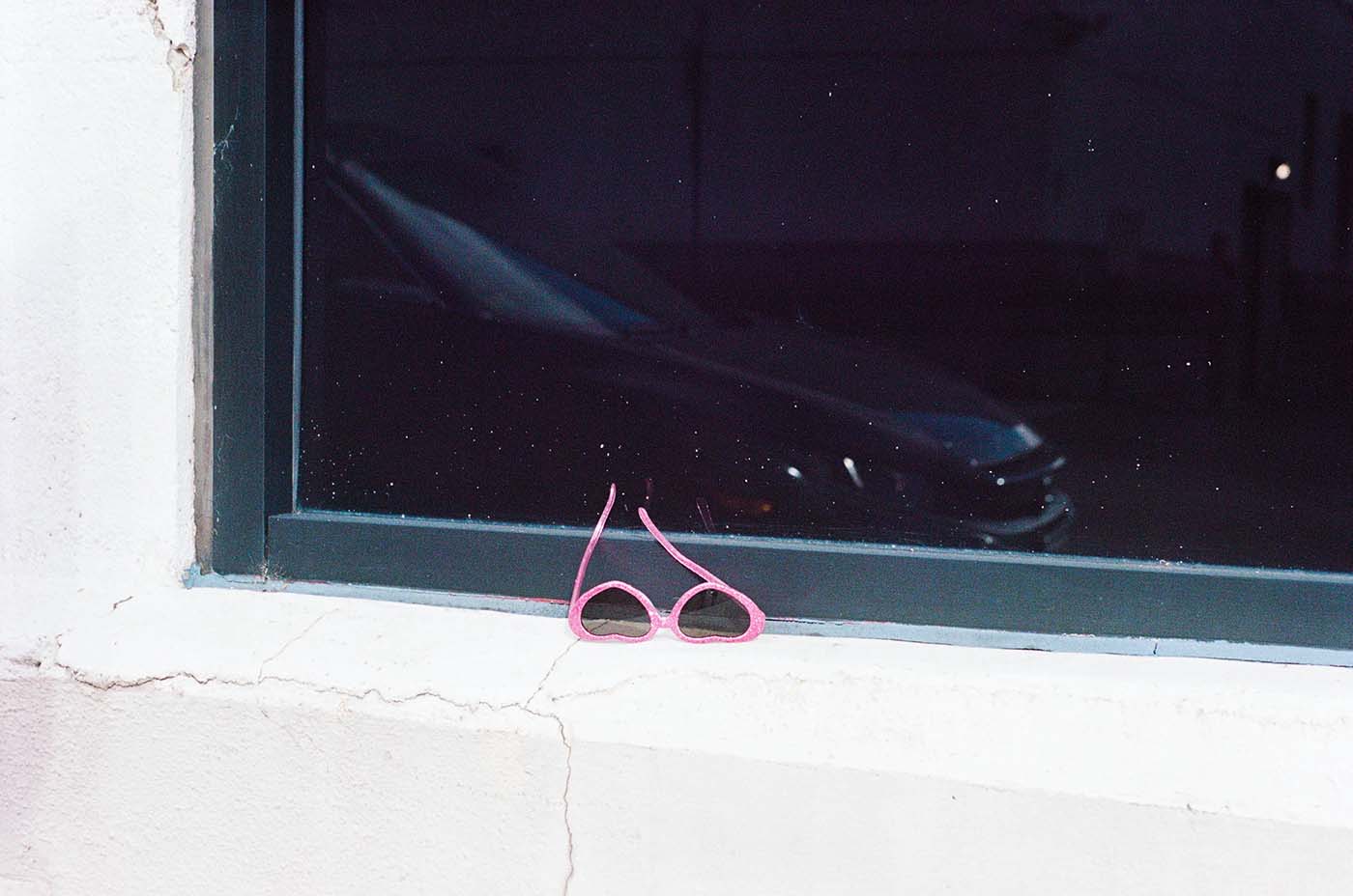 Heart-shaped glasses left on windowsill